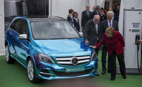 German Chancellor Angela Merkel (R), Transport Minister Peter Ramsauer (R, back) and CEO of German carmaker Daimler Dieter Zetsche look at a German Chancellor Angela Merkel (R), Transport Minister Peter Ramsauer (R, back) and CEO of German carmaker Daimler Dieter Zetsche look at a