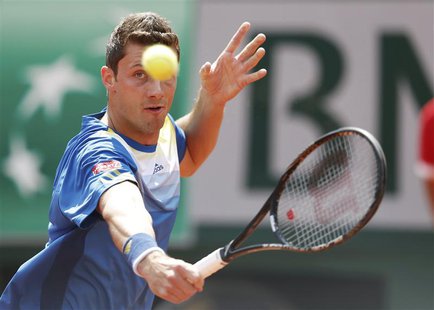 Daniel Brands of Germany hits a return to Rafael Nadal of Spain during their men's singles match at the French Open tennis tournament at the Daniel Brands of Germany hits a return to Rafael Nadal of Spain during their men's singles match at the French Open tennis tournament at the