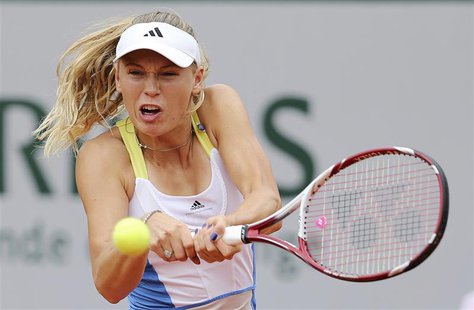 Caroline Wozniacki of Denmark hits a return to Laura Robson of Britain during their women's singles match at the French Open tennis tourname Caroline Wozniacki of Denmark hits a return to Laura Robson of Britain during their women's singles match at the French Open tennis tourname