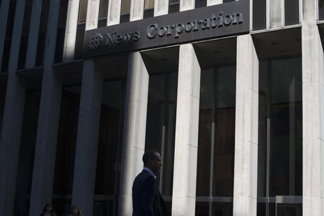 Passers-by walk near the News Corporation building in New York June 28, 2012. REUTERS/Keith Bedford Passers-by walk near the News Corporation building in New York June 28, 2012. REUTERS/Keith Bedford