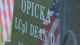 An American flag is reflected on the headstone of Marine Lance Corporal Dean Opicka of Casco on Sunday, May 26, 2013. LCpl. Opicka died in Iraq in 2008. (courtesy of FOX 11). An American flag is reflected on the headstone of Marine Lance Corporal Dean Opicka of Casco on Sunday, May 26, 2013. LCpl. Opicka died in Iraq in 2008. (courtesy of FOX 11).