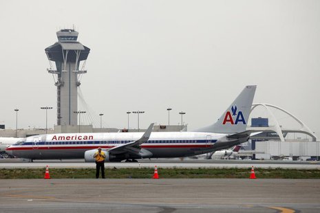 An American Airlines jet passes the Air Traffic Control Tower on the runway at Los Angeles International Airport (LAX), California April 24, An American Airlines jet passes the Air Traffic Control Tower on the runway at Los Angeles International Airport (LAX), California April 24,