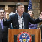 Colorado Governor John Hickenlooper (C) speaks before he signs into law the civil unions act in Denver March 21, 2013. REUTERS/Rick Wilking