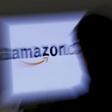 A zoomed illustration image of a man looking at a computer monitor showing the logo of Amazon is seen in Vienna November 26, 2012. REUTERS/L