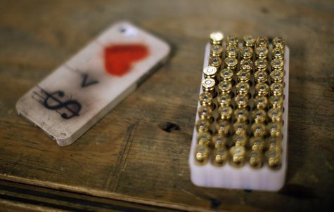 A case of bullets is seen next to an iPhone at the Los Angeles gun club in Los Angeles, January 23, 2013. Picture taken January 23, 2013. RE A case of bullets is seen next to an iPhone at the Los Angeles gun club in Los Angeles, January 23, 2013. Picture taken January 23, 2013. RE