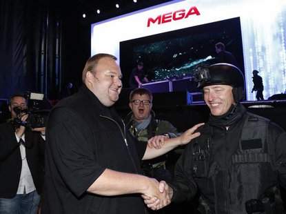 An actor in police costume greets Megaupload founder Kim Dotcom (L) as he launches his new file sharing site "Mega" in Auckland January 20, An actor in police costume greets Megaupload founder Kim Dotcom (L) as he launches his new file sharing site "Mega" in Auckland January 20,