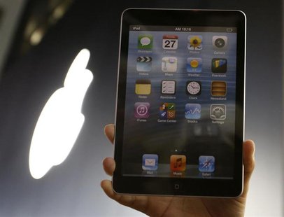 A man holds up a mock model of Apple's new iPad mini as he waits for the release of the tablet in front of the Apple Store Ginza in Tokyo No A man holds up a mock model of Apple's new iPad mini as he waits for the release of the tablet in front of the Apple Store Ginza in Tokyo No