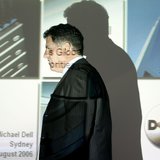 Founder and chairman of Dell computers Michael Dell passes a screen projection before speaking at a news conference in Sydney August 14, 200