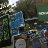 A man is reflected on the glass door of a Nokia showroom in New Delhi March 28, 2013. REUTERS/Mansi Thapliyal