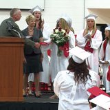 Coldwater High School senior Kylie Dudek receives a standing ovation from her classmates after a state proclamation honoring her athletic and academic achievements was read by State Senator Bruce Caswell during Senior Convocation on May 31, 2013.
