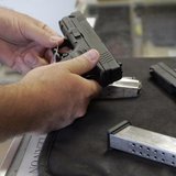 A customer inspects a 9mm handgun at Rink's Gun and Sport in the Chicago, suburb of Lockport, Illinois in this June 26, 2008 file photograph A customer inspects a 9mm handgun at Rink's Gun and Sport in the Chicago, suburb of Lockport, Illinois in this June 26, 2008 file photograph