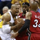Indiana Pacers' David West (L) battles to the basket against Miami Heat's LeBron James (C) and Ray Allen in Game 6 of their NBA Eastern Conf