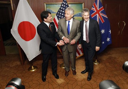 U.S. Defense Secretary Chuck Hagel (C), Japan's Defence Minister Itsunori Onodera (L) and Australia's Defence Minister Stephen Smith react a U.S. Defense Secretary Chuck Hagel (C), Japan's Defence Minister Itsunori Onodera (L) and Australia's Defence Minister Stephen Smith react a