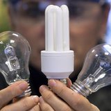 An employee shows a traditional light bulb (R) and two low-energy consumption bulbs at the Osram factory in Molsheim, eastern France Decembe An employee shows a traditional light bulb (R) and two low-energy consumption bulbs at the Osram factory in Molsheim, eastern France Decembe