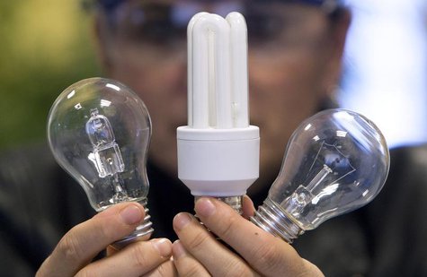 An employee shows a traditional light bulb (R) and two low-energy consumption bulbs at the Osram factory in Molsheim, eastern France Decembe An employee shows a traditional light bulb (R) and two low-energy consumption bulbs at the Osram factory in Molsheim, eastern France Decembe