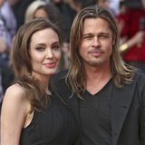 Angelina Jolie poses with her husband Brad Pitt as they arrive for the world premiere of his film World War Z in London June 2, 2013. REUTER Angelina Jolie poses with her husband Brad Pitt as they arrive for the world premiere of his film World War Z in London June 2, 2013. REUTER