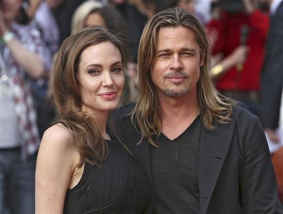 Angelina Jolie poses with her husband Brad Pitt as they arrive for the world premiere of his film World War Z in London June 2, 2013. REUTER Angelina Jolie poses with her husband Brad Pitt as they arrive for the world premiere of his film World War Z in London June 2, 2013. REUTER