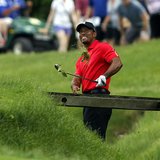 Tiger Woods of the U.S. hits his second shot from the rough on the 11th hole during the final round of the Memorial Tournament at Muirfield 