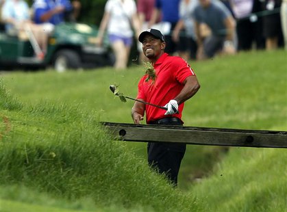 Tiger Woods of the U.S. hits his second shot from the rough on the 11th hole during the final round of the Memorial Tournament at Muirfield Tiger Woods of the U.S. hits his second shot from the rough on the 11th hole during the final round of the Memorial Tournament at Muirfield
