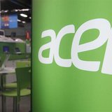 A shop attendant sits in an Acer booth in a computer mall in Taipei March 19, 2013. REUTERS/Pichi Chuang