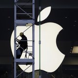 A worker climbs outside an Apple store in Hong Kong April 10, 2013. REUTERS/Bobby Yip