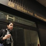 A woman walks out of an Internal Revenue Service office in New York April 18, 2011. REUTERS/Lucas Jackson