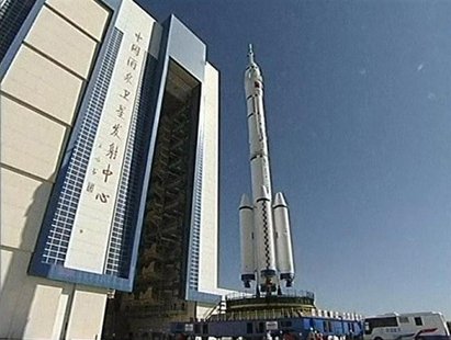 China's new manned Shenzhou-10 spacecraft and its carrier Long March 2-F rocket are seen as they are transferred to their launching site at China's new manned Shenzhou-10 spacecraft and its carrier Long March 2-F rocket are seen as they are transferred to their launching site at