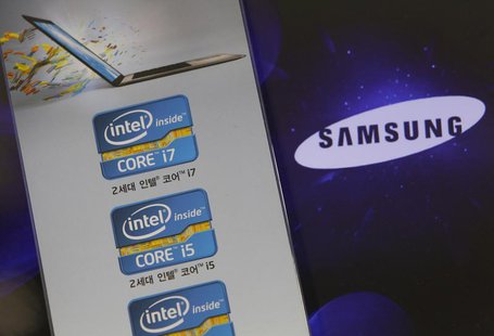 The Samsung Electronics logo is seen on a laptop computer screen (R) in front of an advertisement board promoting Intel processors at a stor The Samsung Electronics logo is seen on a laptop computer screen (R) in front of an advertisement board promoting Intel processors at a stor