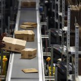 A worker packs boxes at Amazon's logistics centre in Graben near Augsburg December 17, 2012. REUTERS/Michael Dalder A worker packs boxes at Amazon's logistics centre in Graben near Augsburg December 17, 2012. REUTERS/Michael Dalder