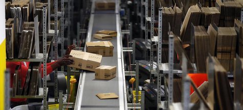 A worker packs boxes at Amazon's logistics centre in Graben near Augsburg December 17, 2012. REUTERS/Michael Dalder A worker packs boxes at Amazon's logistics centre in Graben near Augsburg December 17, 2012. REUTERS/Michael Dalder