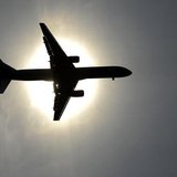 A plane approaching Leeds Bradford airport passes in front of the sun during the second test cricket match between England and New Zealand a