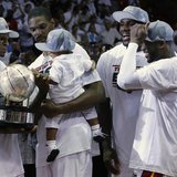 Miami Heat's Dwyane Wade (R), LeBron James (2nd R), Chris Bosh (back C) and his son Jackson look on as Ray Allen holds the Eastern Conferenc Miami Heat's Dwyane Wade (R), LeBron James (2nd R), Chris Bosh (back C) and his son Jackson look on as Ray Allen holds the Eastern Conferenc