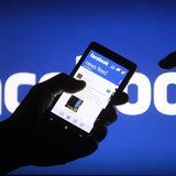 A smartphone user shows the Facebook application on his phone in the central Bosnian town of Zenica, in this photo illustration taken May 2,