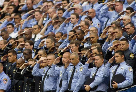 Firefighters stand and salute during a memorial service for four Houston firefighters in Houston, Texas June 5, 2013. REUTERS/Richard Carson Firefighters stand and salute during a memorial service for four Houston firefighters in Houston, Texas June 5, 2013. REUTERS/Richard Carson