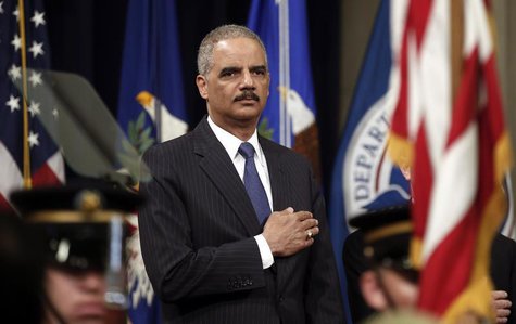 U.S. Attorney General Eric Holder puts his hand to his heart during the national anthem as he hosts a special naturalization ceremony at the U.S. Attorney General Eric Holder puts his hand to his heart during the national anthem as he hosts a special naturalization ceremony at the