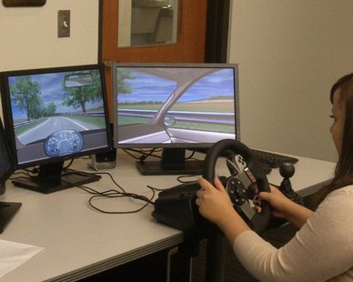 A teen volunteer drives on a simulator at Holland Public Safety Headquarters in order to show the effects of distracted driving. A teen volunteer drives on a simulator at Holland Public Safety Headquarters in order to show the effects of distracted driving.