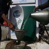 A man fills a canister with petrol that he says was brought from Iran, at a roadside petrol station on the outskirts of Quetta February 13, 