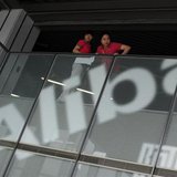 Employees stand next to a logo of Alibaba (China) Technology Co. Ltd during a media tour organized by government officials at its headquarte