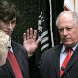 Pat Quinn (R) is sworn in as Governor of Illinois by Appellate Judge Anne Burke while son Patrick IV looks on, after the removal of impeache