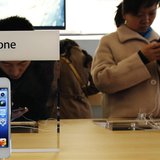 Visitors try the iPhone at an Apple Store in Beijing March 28, 2013. REUTERS/Kim Kyung-Hoon