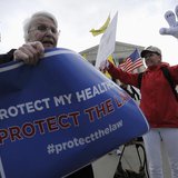 Obama healthcare legislation supporter Margot Smith (L) of California tries to block out legislation opponent Janis Haddon (R) of Georgia as