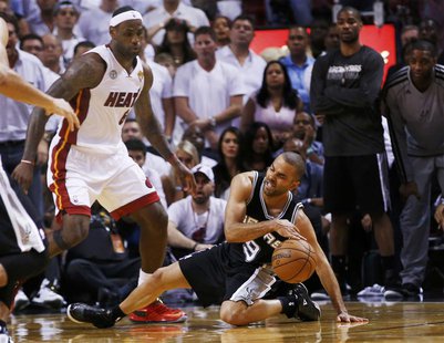 San Antonio Spurs' Tony Parker slips while being guarded by Miami Heat's LeBron James (L) during the fourth quarter in Game 1 of their NBA F San Antonio Spurs' Tony Parker slips while being guarded by Miami Heat's LeBron James (L) during the fourth quarter in Game 1 of their NBA F