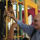 Executive Director of the United Nations Children's Fund (UNICEF) Anthony Lake smiles as he fist bumps with Syrian children during a visit t