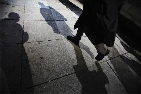 Shadows are seen as a man walks down Bay Street in the financial district in Toronto, March 11, 2009. REUTERS/Mark Blinch Shadows are seen as a man walks down Bay Street in the financial district in Toronto, March 11, 2009. REUTERS/Mark Blinch