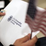 A man holds a U.S. flag while receiving his proof of U.S. citizenship during a ceremony in San Francisco, California January 30, 2013. REUTE A man holds a U.S. flag while receiving his proof of U.S. citizenship during a ceremony in San Francisco, California January 30, 2013. REUTE