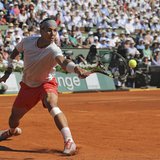 Rafael Nadal of Spain hits a return to Novak Djokovic of Serbia during their men's singles semi-final match at the French Open tennis tourna