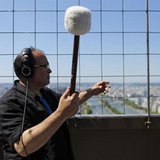 U.S. composer Joseph Bertolozzi makes sounds by striking the surface of the Eiffel Tower for a musical project called 'Tower music' in Paris U.S. composer Joseph Bertolozzi makes sounds by striking the surface of the Eiffel Tower for a musical project called 'Tower music' in Paris