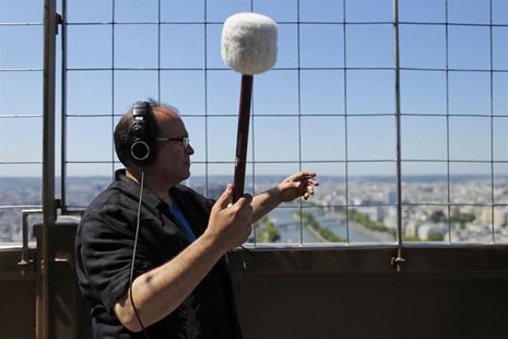 U.S. composer Joseph Bertolozzi makes sounds by striking the surface of the Eiffel Tower for a musical project called 'Tower music' in Paris U.S. composer Joseph Bertolozzi makes sounds by striking the surface of the Eiffel Tower for a musical project called 'Tower music' in Paris
