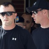 Private First Class Bradley Manning, 25, (in beret obscured behind security) leaves the first day of his trial at Fort Meade in Maryland, Ju Private First Class Bradley Manning, 25, (in beret obscured behind security) leaves the first day of his trial at Fort Meade in Maryland, Ju