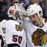 Chicago Blackhawks goalie Corey Crawford (50) gets a pat on the head from defenseman Sheldon Brookbank after their team defeated the Los Ang